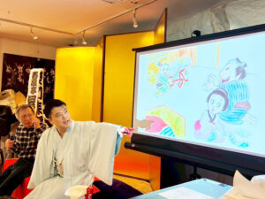 土肥ヨシの今回の作品をプロジェクターで投影してそれについて話す昇吉様